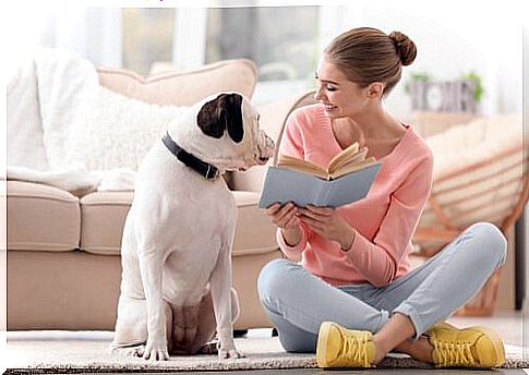 Girl shows book to her dog